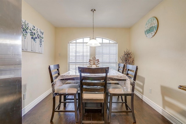 dining room featuring baseboards and dark wood finished floors