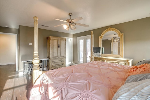 bedroom with visible vents, access to outside, wood finished floors, baseboards, and ceiling fan