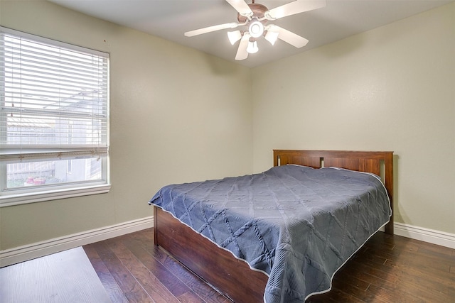 bedroom featuring hardwood / wood-style flooring, multiple windows, baseboards, and ceiling fan