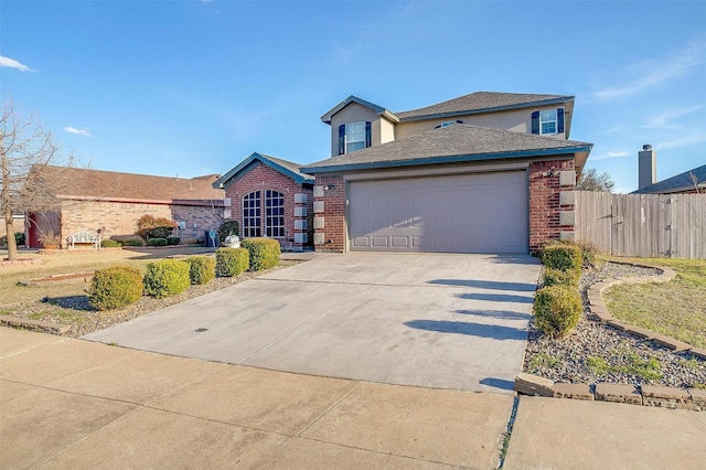 traditional home featuring brick siding, concrete driveway, an attached garage, and fence