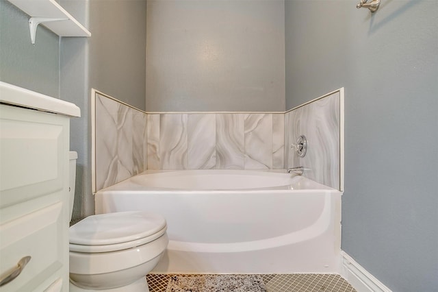 bathroom featuring a garden tub, tile patterned flooring, and toilet