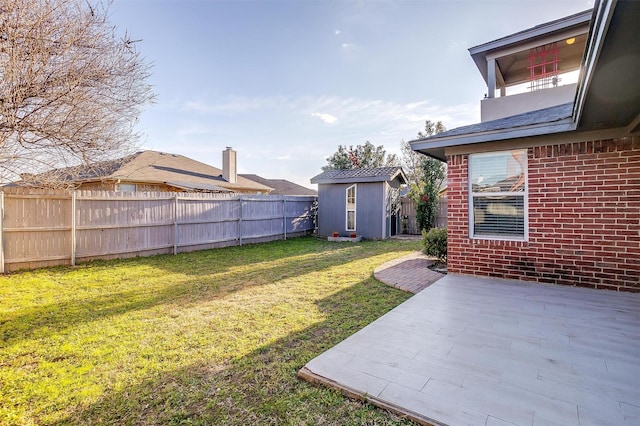 view of yard with a patio area, a shed, an outdoor structure, and a fenced backyard