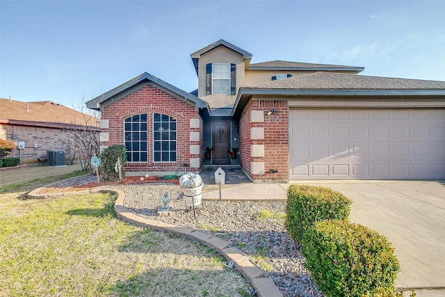 traditional home featuring a front lawn, driveway, cooling unit, an attached garage, and brick siding