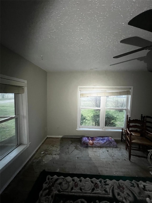 spare room featuring baseboards, lofted ceiling, a textured ceiling, and a ceiling fan
