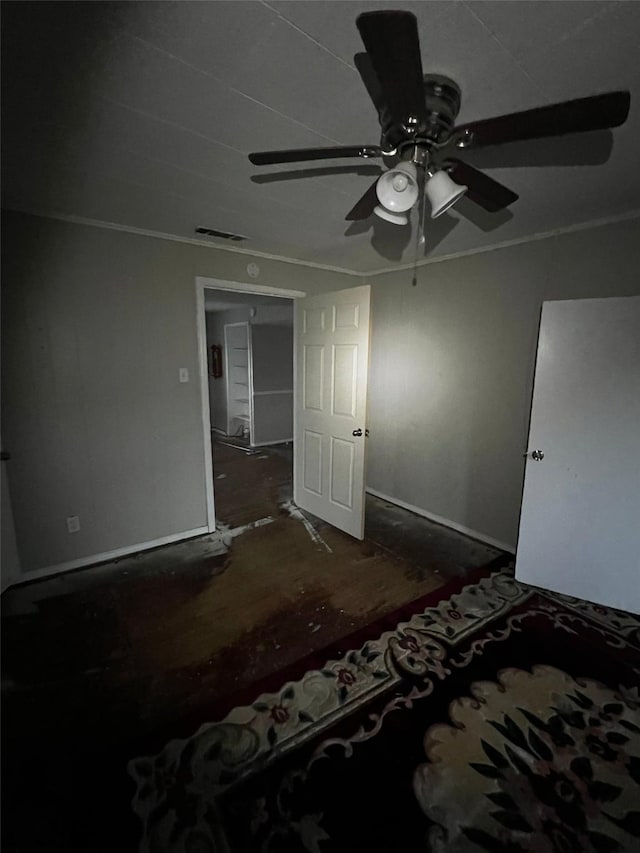 unfurnished bedroom with visible vents, ornamental molding, and a ceiling fan