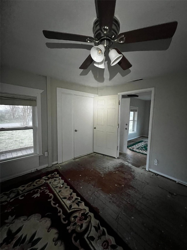 unfurnished bedroom featuring a closet, visible vents, and ceiling fan