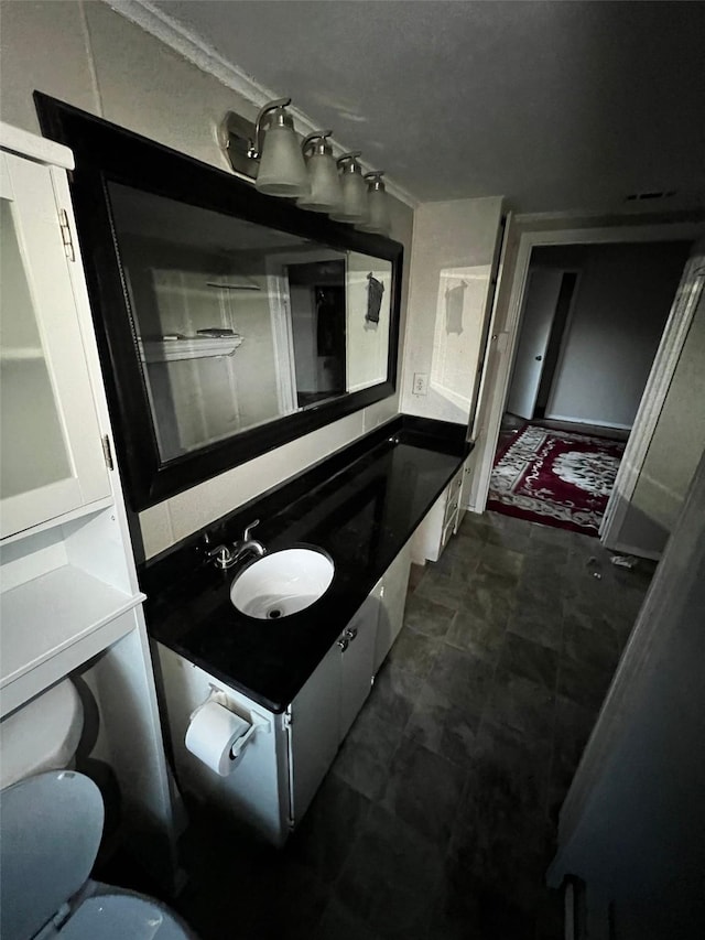 bathroom featuring toilet and vanity