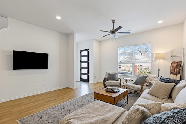 living area featuring a wealth of natural light, recessed lighting, light wood finished floors, and baseboards