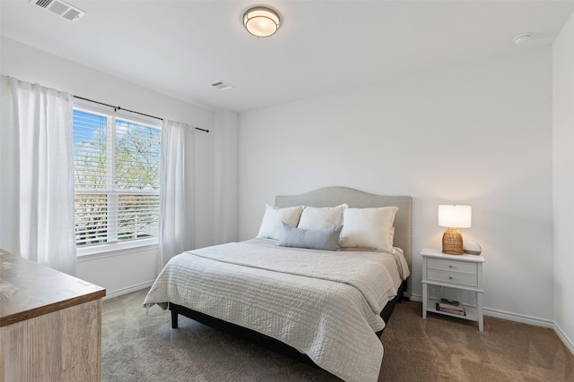 bedroom with visible vents, light carpet, and baseboards