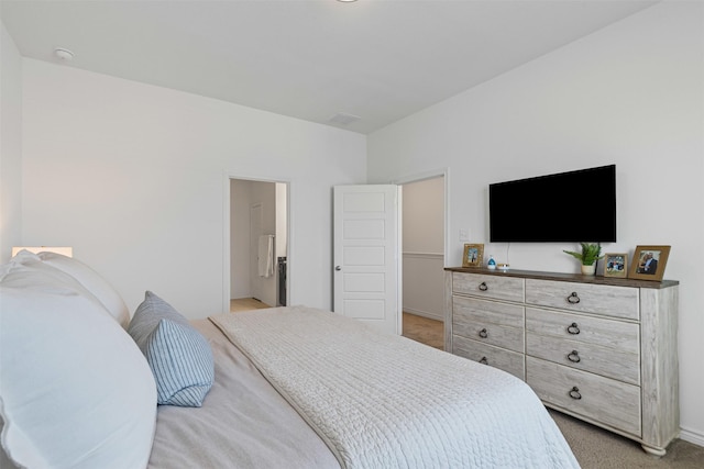 bedroom featuring light carpet