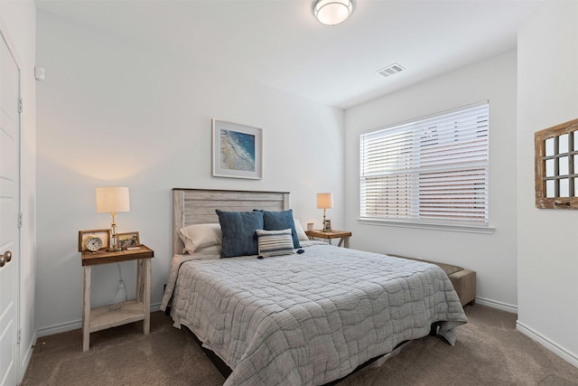 bedroom with visible vents, baseboards, and carpet