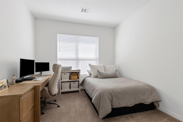 bedroom featuring visible vents and light carpet