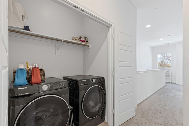 clothes washing area featuring baseboards, laundry area, recessed lighting, light carpet, and washer and clothes dryer