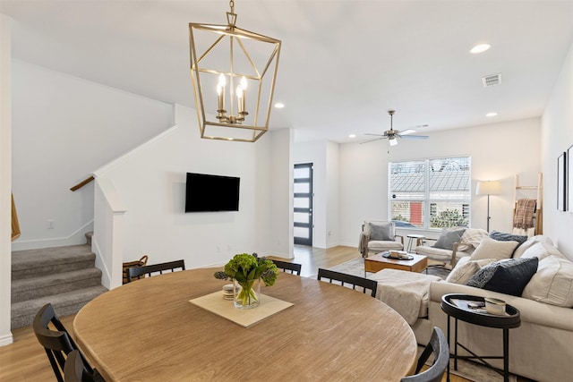 dining room with recessed lighting, stairway, light wood-style floors, and visible vents