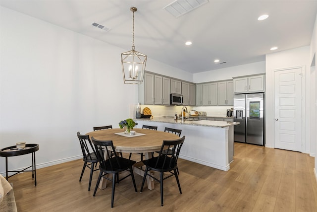 dining space featuring recessed lighting, visible vents, and light wood-style flooring