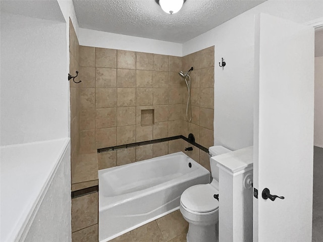 bathroom featuring shower / tub combination, toilet, tile patterned floors, and a textured ceiling