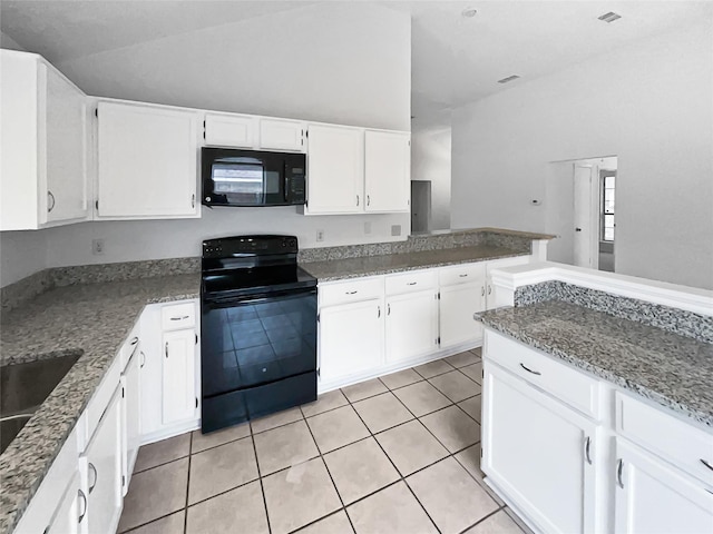 kitchen with light tile patterned floors, visible vents, black appliances, white cabinets, and vaulted ceiling