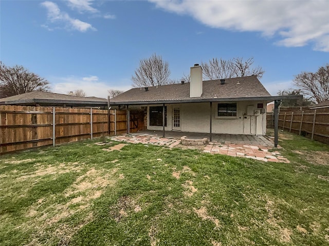 rear view of house with a patio, a fenced backyard, a shingled roof, a chimney, and a lawn