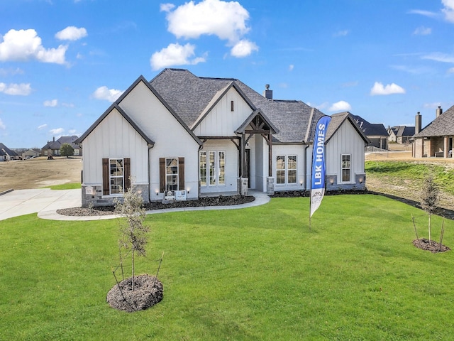 view of front of property featuring board and batten siding and a front yard