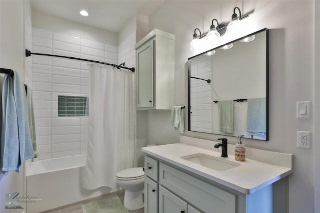 bathroom featuring vanity, toilet, and shower / tub combo with curtain