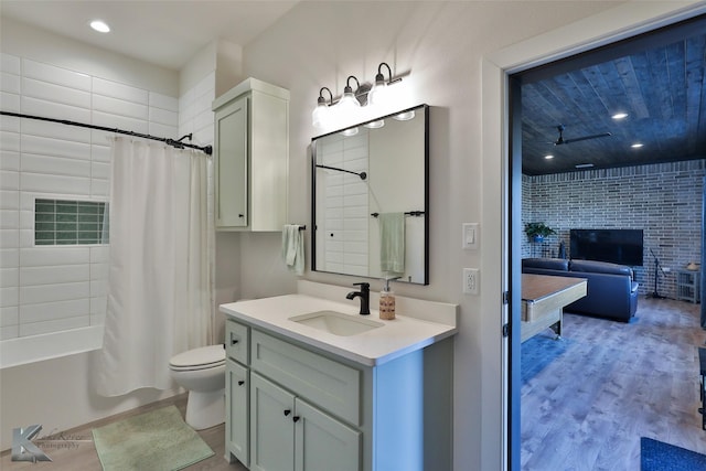 full bathroom with toilet, recessed lighting, shower / tub combo, wood finished floors, and vanity