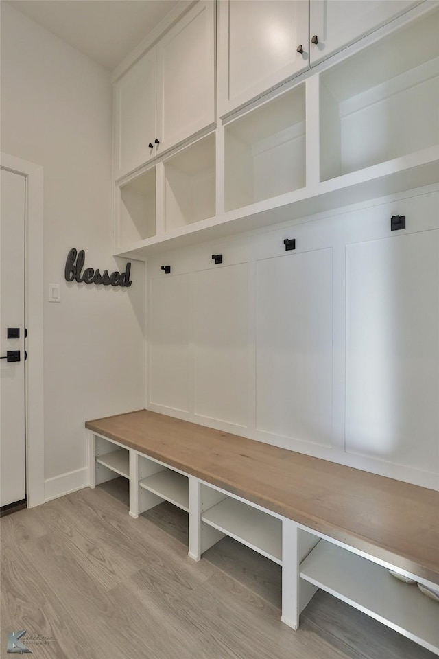 mudroom featuring light wood-style floors and baseboards