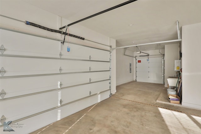 garage with a garage door opener and water heater