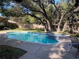 view of pool featuring a pool with connected hot tub