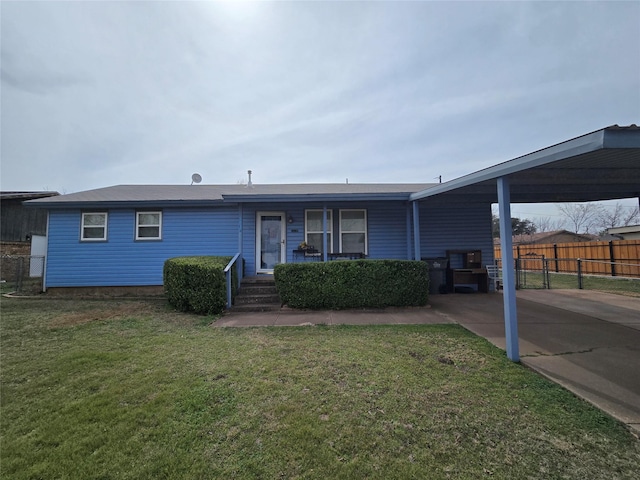 view of front of house with a carport, a front lawn, and fence