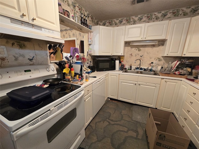 kitchen featuring a sink, white appliances, under cabinet range hood, and wallpapered walls