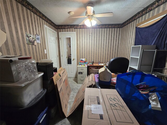 interior space featuring a textured ceiling, wallpapered walls, and a ceiling fan