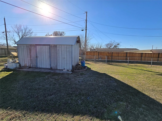 view of yard featuring a storage shed, an outbuilding, and fence