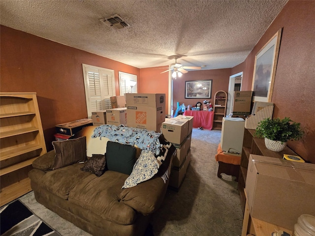 bedroom with visible vents, carpet flooring, a textured ceiling, and a ceiling fan