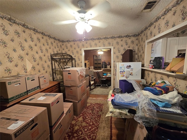 miscellaneous room featuring wallpapered walls, visible vents, and a textured ceiling