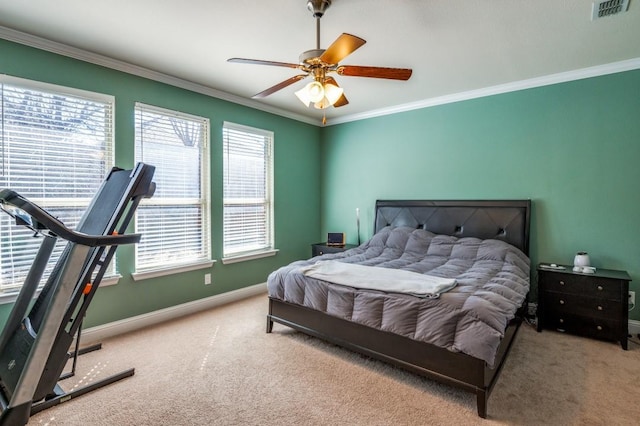 carpeted bedroom featuring visible vents, a ceiling fan, crown molding, and baseboards