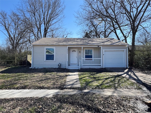 view of front facade featuring a porch, an attached garage, and driveway