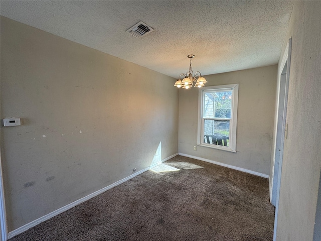 carpeted empty room featuring visible vents, baseboards, a textured ceiling, and an inviting chandelier