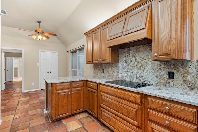 kitchen with backsplash, a peninsula, brown cabinetry, black electric stovetop, and vaulted ceiling