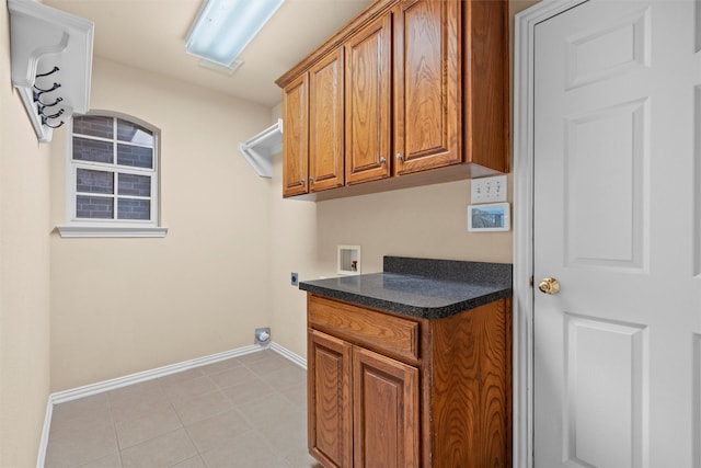 clothes washing area featuring hookup for a washing machine, light tile patterned floors, baseboards, hookup for an electric dryer, and cabinet space