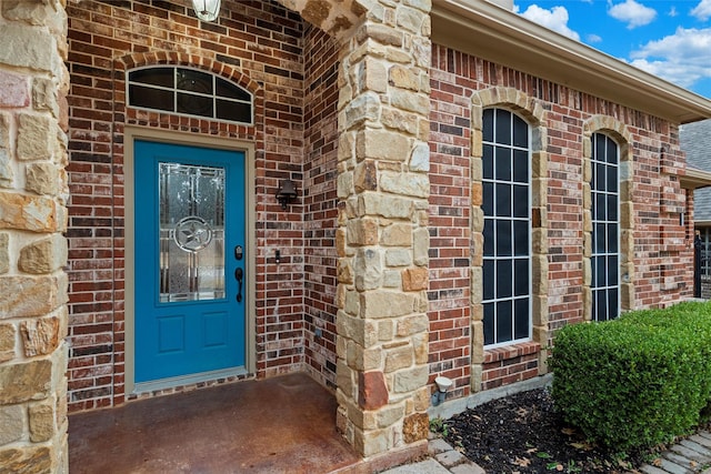 property entrance featuring brick siding