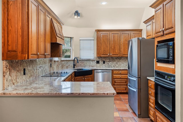 kitchen featuring a sink, backsplash, black appliances, and brown cabinetry