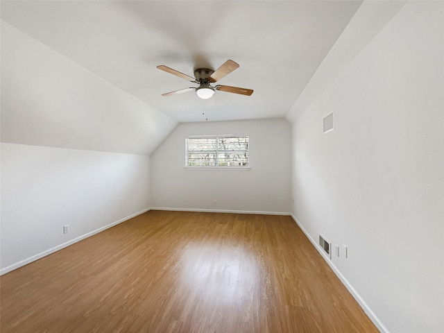 bonus room with visible vents, baseboards, ceiling fan, vaulted ceiling, and wood finished floors