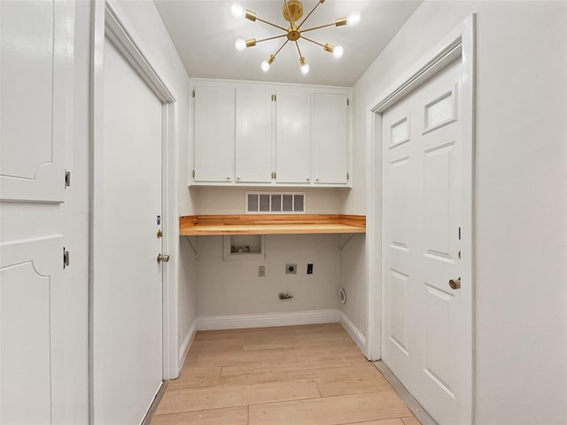 washroom with visible vents, cabinet space, light wood-style floors, hookup for an electric dryer, and hookup for a washing machine