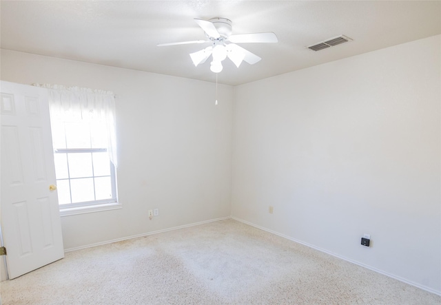 empty room featuring visible vents, baseboards, and ceiling fan