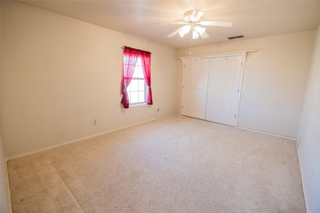 unfurnished bedroom with visible vents, baseboards, carpet flooring, a closet, and a ceiling fan