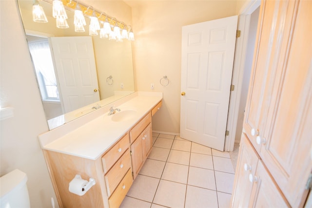 bathroom with tile patterned floors, toilet, vanity, and baseboards