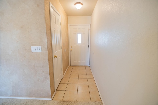 doorway to outside featuring light tile patterned floors