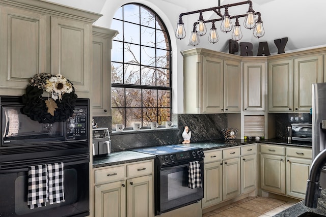 kitchen featuring light tile patterned floors, black appliances, dark countertops, cream cabinets, and tasteful backsplash