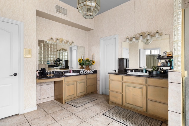 full bath with a sink, visible vents, two vanities, and wallpapered walls