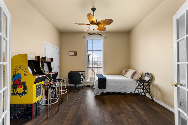 bedroom with baseboards, wood finished floors, and a ceiling fan